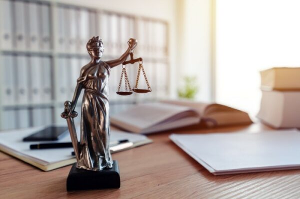 Photo of desk with legal scales figurine